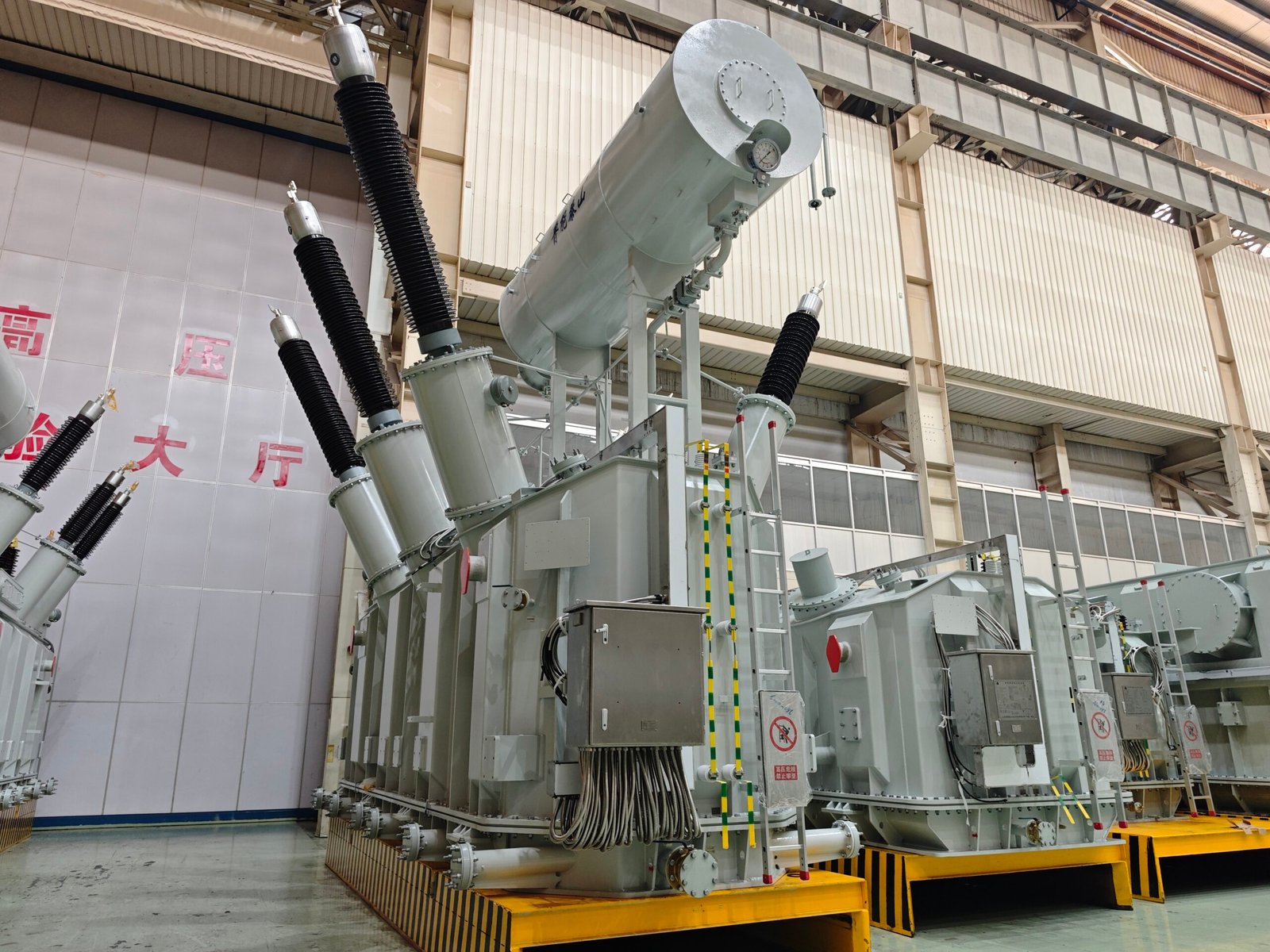 High-voltage power transformer at Taishan Transformer factory, showcasing advanced electrical engineering and manufacturing capabilities.