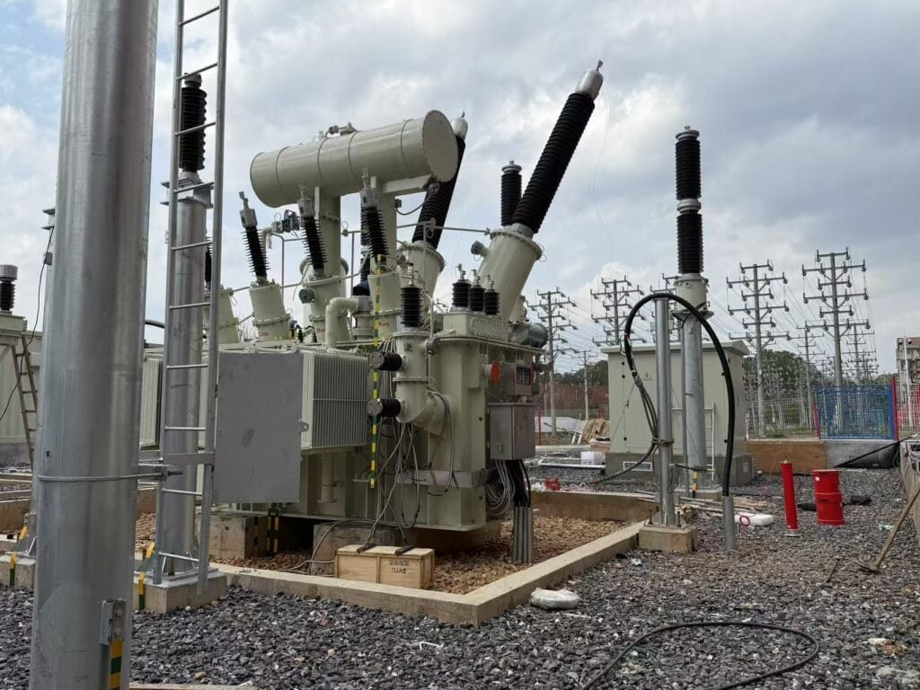 High-voltage electrical transformer at Taishan Transformer facility with protective insulators and electrical infrastructure.